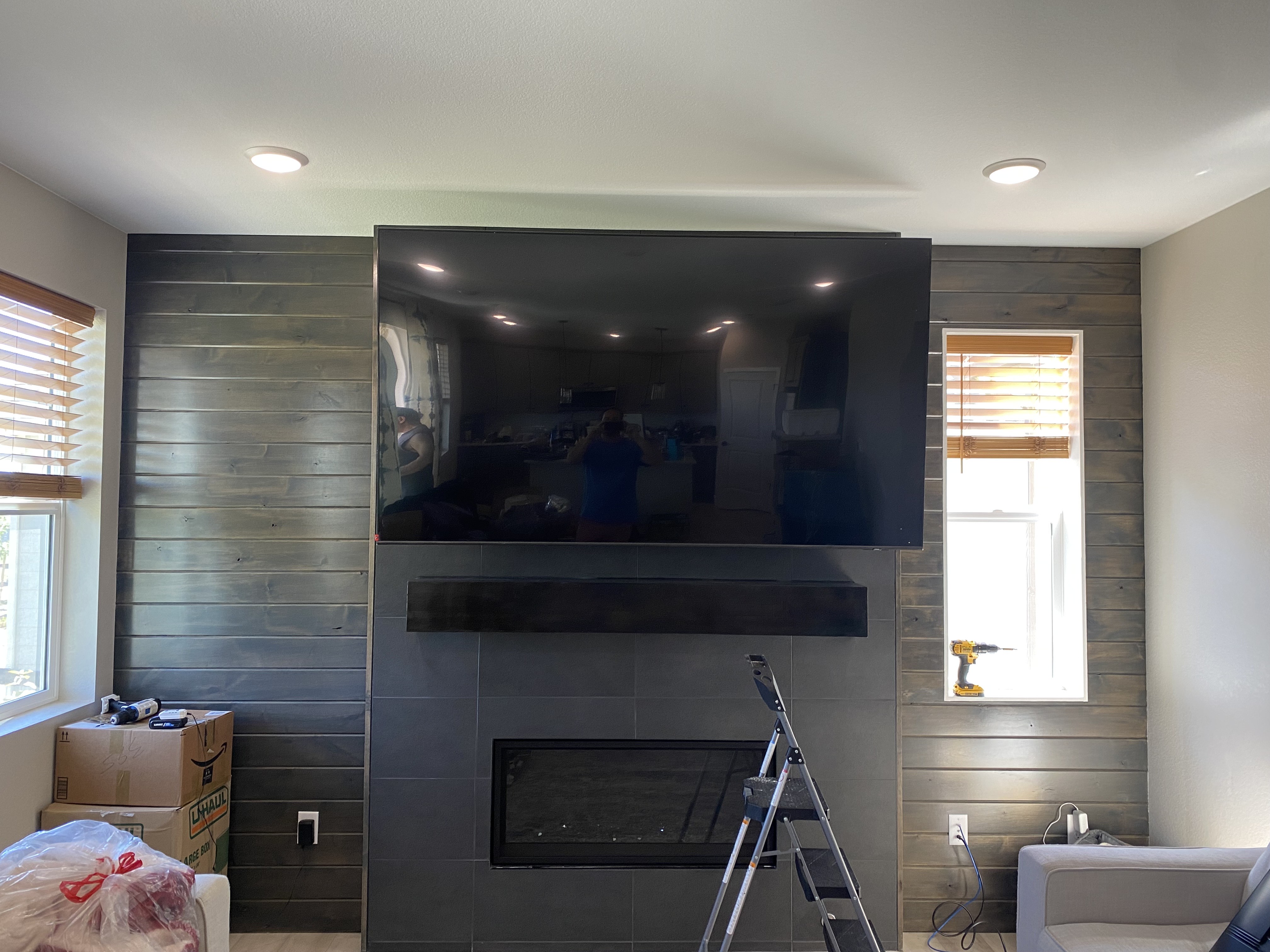 After — TV mounted on tile fireplace wall, cords hidden